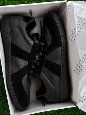 Black leather German Army trainer style sneakers.